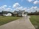 View of the home with a long driveway and well manicured yard at 1324 Sage Pine Cir, Clover, SC 29710