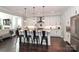 Modern kitchen with a large island, stainless steel appliances, pendant lighting, and white cabinetry at 13306 Old Store Rd, Huntersville, NC 28078