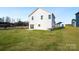 Back exterior view of a two-story home with white siding and a spacious lawn at 1540 Solitude Ct, Kannapolis, NC 28081