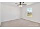 Bright bedroom with carpeted floors, a ceiling fan, and a large window at 1540 Solitude Ct, Kannapolis, NC 28081