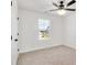 Bedroom showcasing neutral carpet, white walls, a ceiling fan and a window view at 1540 Solitude Ct, Kannapolis, NC 28081