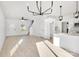 Open-concept living area with modern lighting, stairs, and a doorway to a backyard patio at 1540 Solitude Ct, Kannapolis, NC 28081
