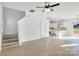 Bright living room with stairs to the left and a view of the white kitchen in the background at 1540 Solitude Ct, Kannapolis, NC 28081