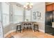 Bright breakfast nook features a wooden table with seating, chandelier and picture window at 1655 Essex Hall Dr, Rock Hill, SC 29730