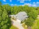 Beautiful two-story home with a well-manicured lawn, lush landscaping, mature trees and an in-ground pool at 174 Logan Crossing Dr, Davidson, NC 28036