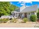 A beautiful backyard featuring a screened porch, landscaping, and brick path at 174 Logan Crossing Dr, Davidson, NC 28036