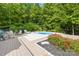 Inviting backyard pool area surrounded by lush greenery and lounge chairs at 174 Logan Crossing Dr, Davidson, NC 28036