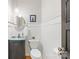 Powder room features pedestal sink, decorative mirror and wainscotting at 174 Logan Crossing Dr, Davidson, NC 28036