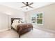 Bedroom with ceiling fan, plush carpet, large window and a wood framed bed at 174 Logan Crossing Dr, Davidson, NC 28036