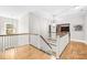 Bright upstairs hallway with hardwood floors, and a view of the living area at 174 Logan Crossing Dr, Davidson, NC 28036