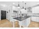 Beautifully renovated kitchen with stainless steel appliances, dark countertops and white cabinets at 174 Logan Crossing Dr, Davidson, NC 28036