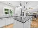 Spacious kitchen with stainless appliances, dark countertops, white cabinets and natural light from a window at 174 Logan Crossing Dr, Davidson, NC 28036