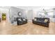 Spacious living room featuring a decorative brick wall, hardwood floors, and access to the modern kitchen at 174 Logan Crossing Dr, Davidson, NC 28036