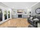 Inviting living room featuring a stone fireplace, hardwood floors, and french doors at 174 Logan Crossing Dr, Davidson, NC 28036