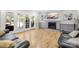 Spacious living room with fireplace, built-in cabinets, and french doors leading to the screened porch at 174 Logan Crossing Dr, Davidson, NC 28036