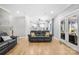 Open-concept living room with hardwood floors and easy access to the modern kitchen at 174 Logan Crossing Dr, Davidson, NC 28036