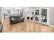 Bright living room with hardwood floors, a black sofa and sliding glass doors to the backyard at 174 Logan Crossing Dr, Davidson, NC 28036