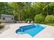 Inviting backyard pool with lounge chairs, lush landscaping and a shed at 174 Logan Crossing Dr, Davidson, NC 28036