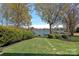 Waterfront backyard with mature trees and well-manicured lawn at 17701 Springwinds Dr, Cornelius, NC 28031