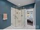 A modern bathroom features a glass-enclosed shower and a serene ambiance at 17701 Springwinds Dr, Cornelius, NC 28031