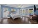 A relaxing bedroom features natural light, and access to a private balcony with lake views at 17701 Springwinds Dr, Cornelius, NC 28031