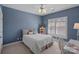 A cozy bedroom with natural light and a relaxing blue color creates a serene atmosphere at 17701 Springwinds Dr, Cornelius, NC 28031