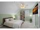 Cozy bedroom featuring a built-in bookcase, ceiling fan, and comfortable furnishings at 17701 Springwinds Dr, Cornelius, NC 28031