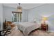 Comfortable bedroom with a window, warm lighting, and tile flooring at 17701 Springwinds Dr, Cornelius, NC 28031
