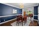 Elegant dining room with hardwood floors, crown molding, and stylish decor at 17701 Springwinds Dr, Cornelius, NC 28031