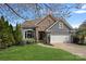Charming home featuring a stone facade, well-manicured lawn, and a two-car garage at 17701 Springwinds Dr, Cornelius, NC 28031