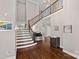 Bright foyer with hardwood floors, a staircase, and elegant decor sets a welcoming tone at 17701 Springwinds Dr, Cornelius, NC 28031