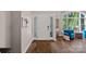 Inviting foyer showcasing hardwood floors, a bright window, and stylish decor at 17701 Springwinds Dr, Cornelius, NC 28031