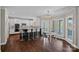 Spacious eat-in kitchen boasts white cabinetry, a large island, and a charming breakfast nook at 17701 Springwinds Dr, Cornelius, NC 28031