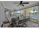Inviting screened-in patio offers serene water views and comfortable outdoor dining space at 17701 Springwinds Dr, Cornelius, NC 28031