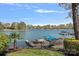Picturesque waterfront view with a private dock, boats, and lush landscaping at 17701 Springwinds Dr, Cornelius, NC 28031