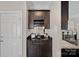 A dark wood wet bar with a sink, storage, and a wine rack, perfect for entertaining at 17701 Springwinds Dr, Cornelius, NC 28031