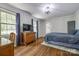 Bedroom with hardwood floors, windows with natural light, and dresser with television at 1774 Hwy 55 E Hwy, Clover, SC 29710