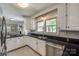 Modern kitchen features black granite countertops, white cabinets, and stainless steel appliances offering sleek design at 1774 Hwy 55 E Hwy, Clover, SC 29710