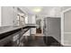 Bright kitchen with white cabinets, stainless steel refrigerator and black countertops at 1774 Hwy 55 E Hwy, Clover, SC 29710