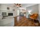 Cozy living room with a brick fireplace, hardwood floors, and an open layout to the kitchen offering comfort and convenience at 1774 Hwy 55 E Hwy, Clover, SC 29710