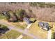 An aerial view shows a tan home's location and large lot, nestled between mature trees and neighboring homes at 2050 Sunswept Ln, York, SC 29745