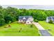 Suburban home with lush green lawns and landscaping including mature trees and a long driveway at 2050 Sunswept Ln, York, SC 29745