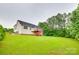 A large green backyard features a deck overlooking a green forest at 2050 Sunswept Ln, York, SC 29745