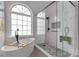 Modern bathroom featuring a freestanding tub and a walk-in shower with glass enclosure and mosaic-tiled floor at 2050 Sunswept Ln, York, SC 29745