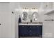 Stylish bathroom featuring a double vanity with marble countertop, elegant mirrors, and modern lighting fixtures at 2050 Sunswept Ln, York, SC 29745