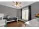 Comfortable bedroom features hardwood floors, natural light, and a ceiling fan at 2050 Sunswept Ln, York, SC 29745