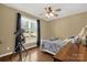 Cozy bedroom with a telescope by the window, ceiling fan, hardwood floors, and natural light at 2050 Sunswept Ln, York, SC 29745