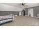 Spacious bedroom with carpeted floors, featuring a ceiling fan and ample storage with two closets at 2050 Sunswept Ln, York, SC 29745