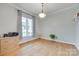 This bedroom features an elegant light fixture and hardwood floors at 2050 Sunswept Ln, York, SC 29745