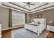 Inviting bedroom with a large window, tray ceiling, hardwood floors, and stylish decor at 2050 Sunswept Ln, York, SC 29745